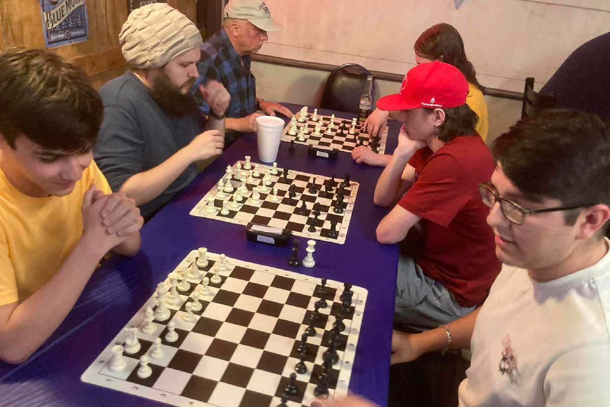 Six people playing chess