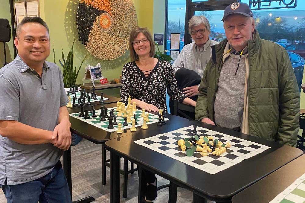 Chess players smiling for the camera