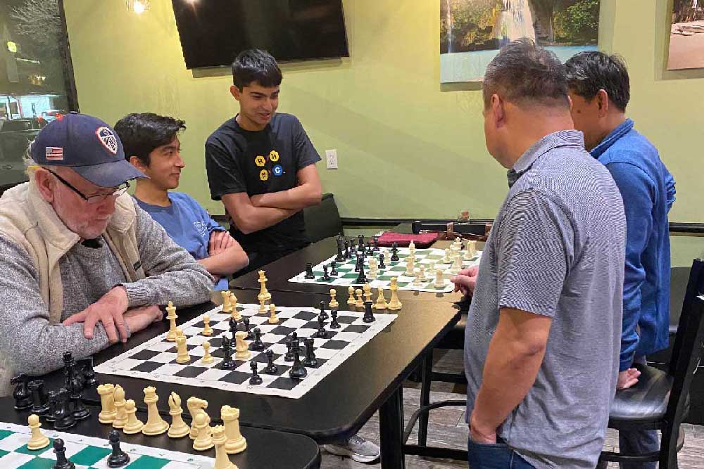 Spectators watching a game of chess