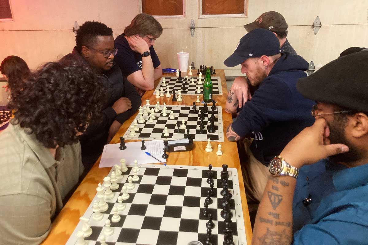 Six chess players engaged in a blitz tournament