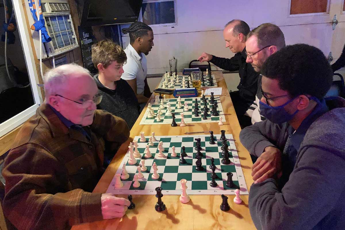 Older and young playing chess